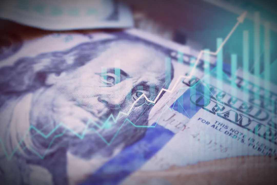 Hundred dollar US bill with a line graph overlaying the entire bill