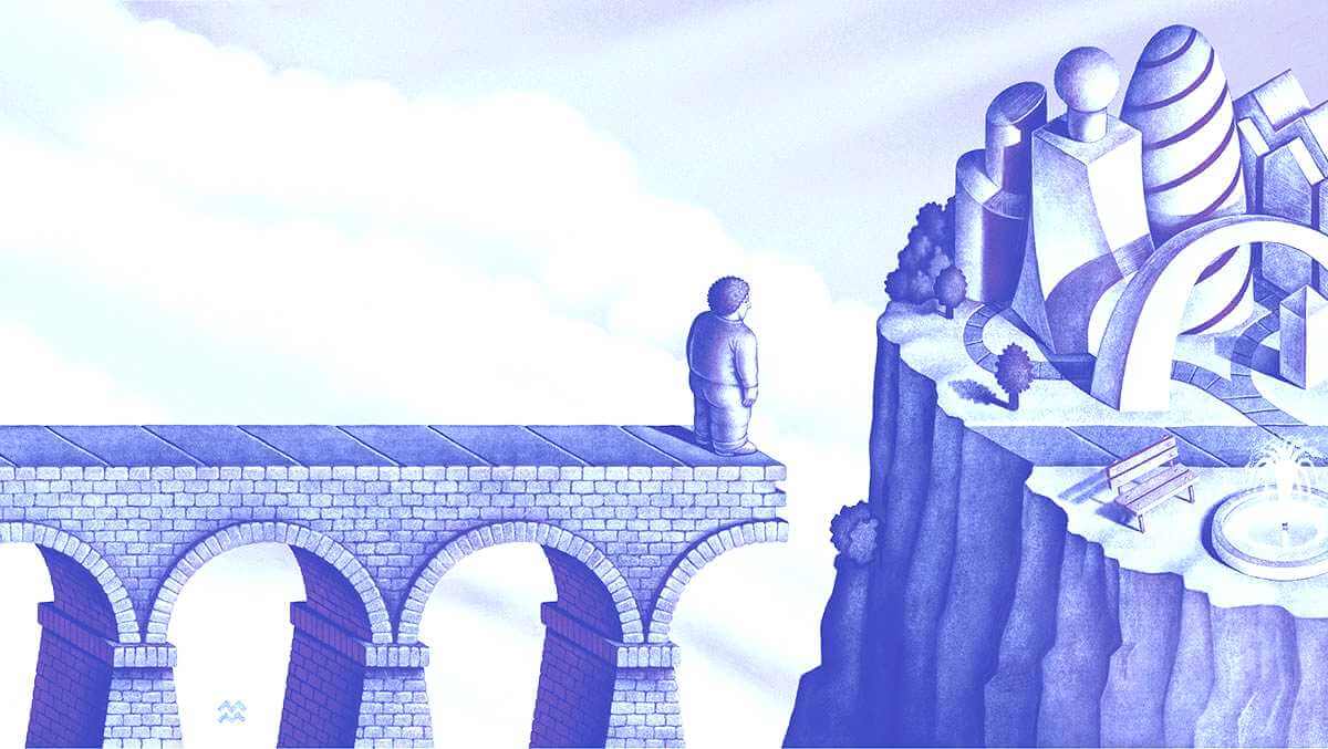 Man standing on brick bridge with a gap between him and a piece of land