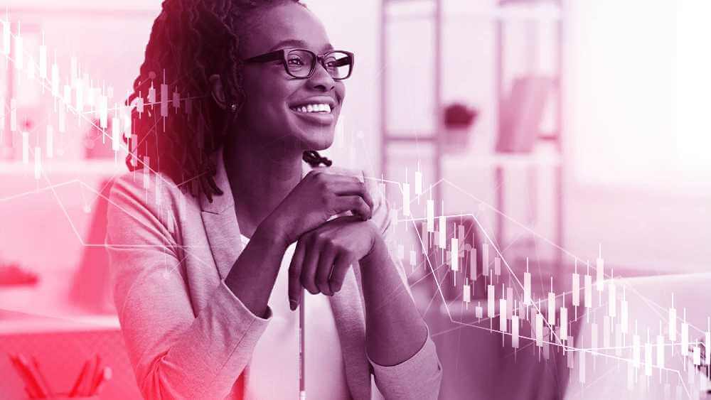 Woman smiling with her hands overlapping one another with her left hand dangling a pencil with trading bars overlaying the image