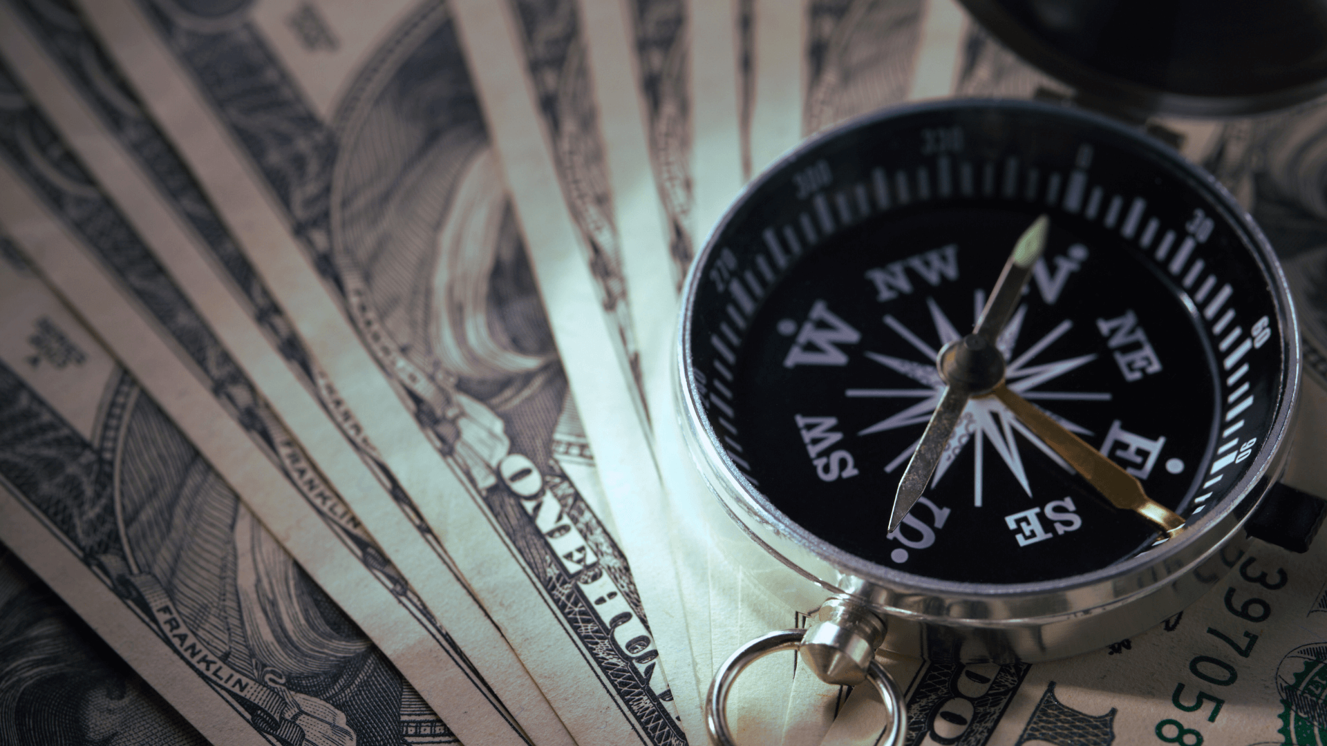 This is a picture of a compass and money. To imply navigating money management complexities.