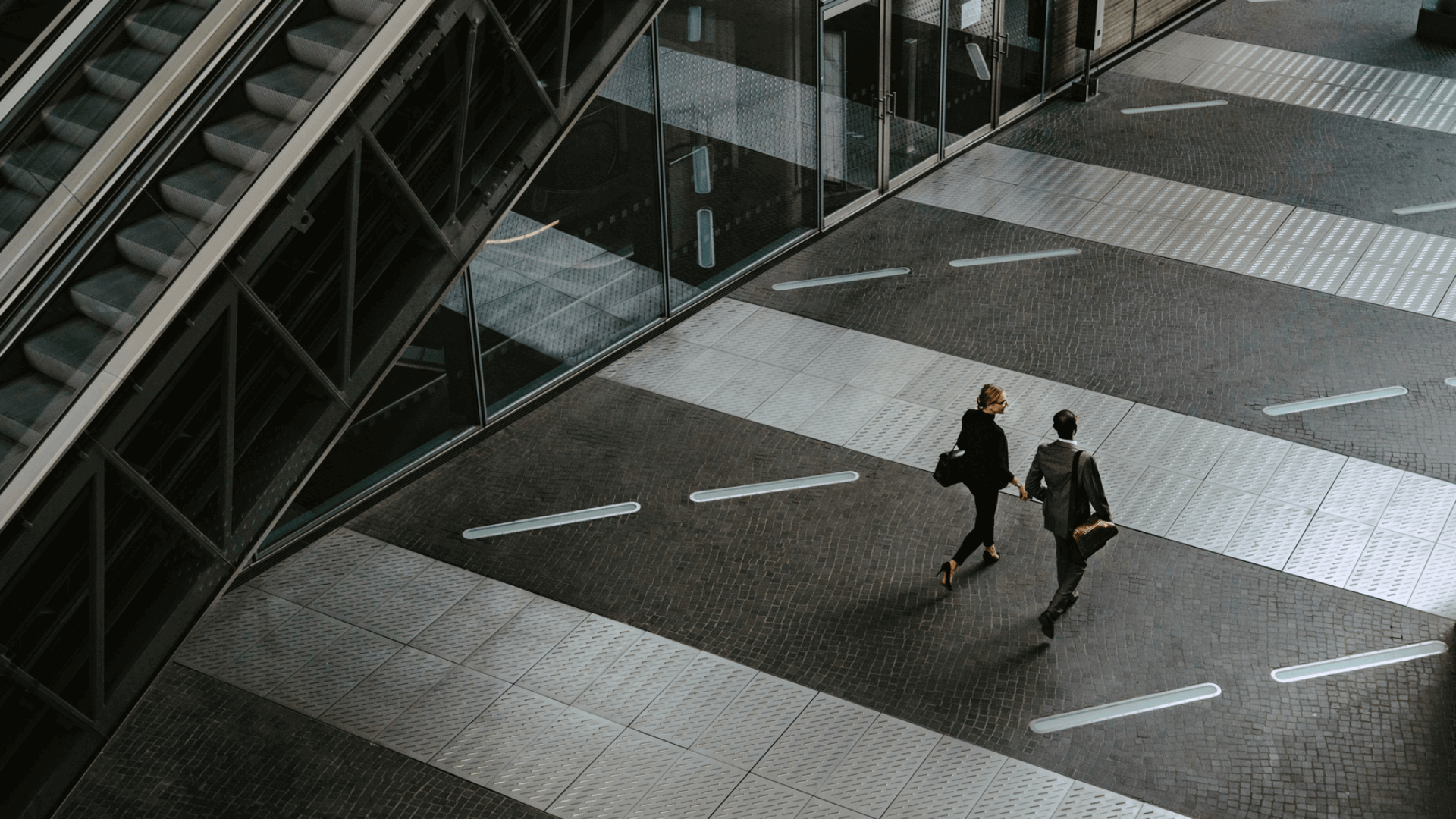 Two business people walking and talking in a high end modern building